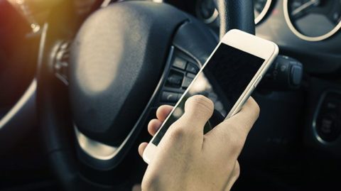 A motorist texting while driving 
